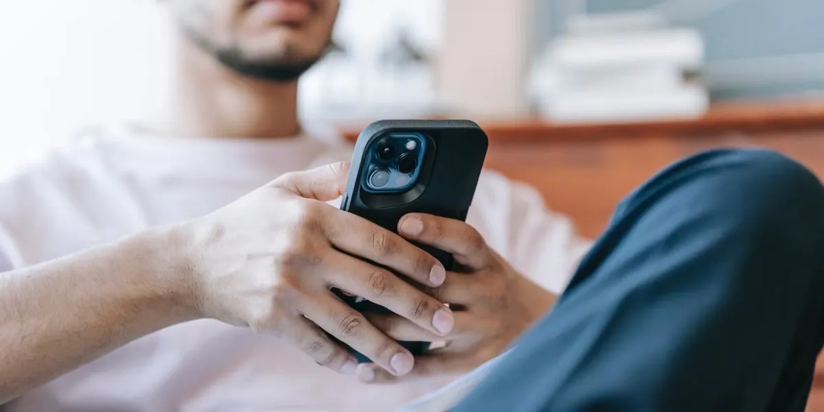 Hands holding a phone, scrolling social media